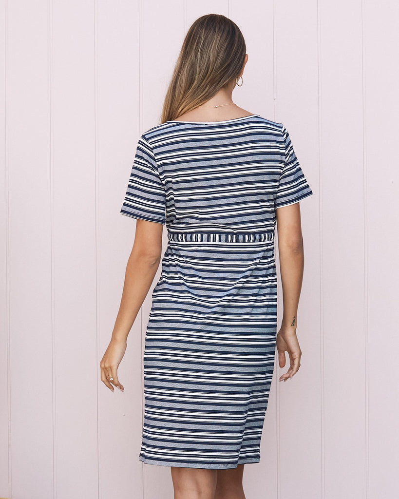 Back View - A pregnant Woman in Maternity Short Sleeve Drawstring Dress in Navy & White Stripes