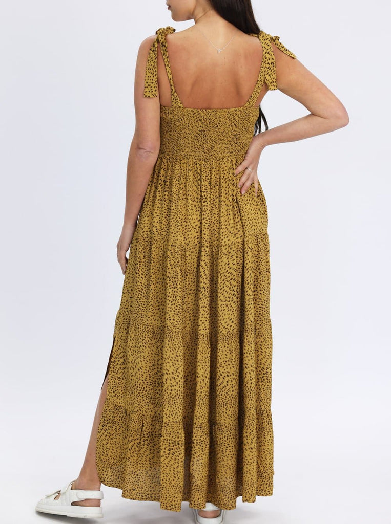 A woman in mustard print maternity dress, back (6656901152862)