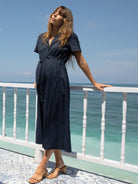 A woman in navy maternity nursing dress, main (6659017015390)