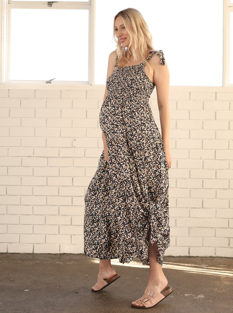 Main View - A pregnant Woman in Floral Long Maternity Maxi Dress in Navy Floral Print