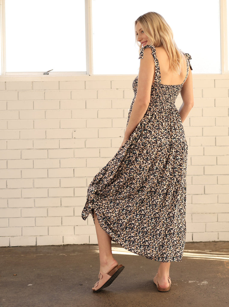 Back View - A pregnant Woman in Floral Long Maternity Maxi Dress in Navy Floral Print