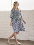 Main View - A pregnant Woman in Purple Floral Print Baby Shower Maternity Dress from Angel Maternity  (6726602162270)