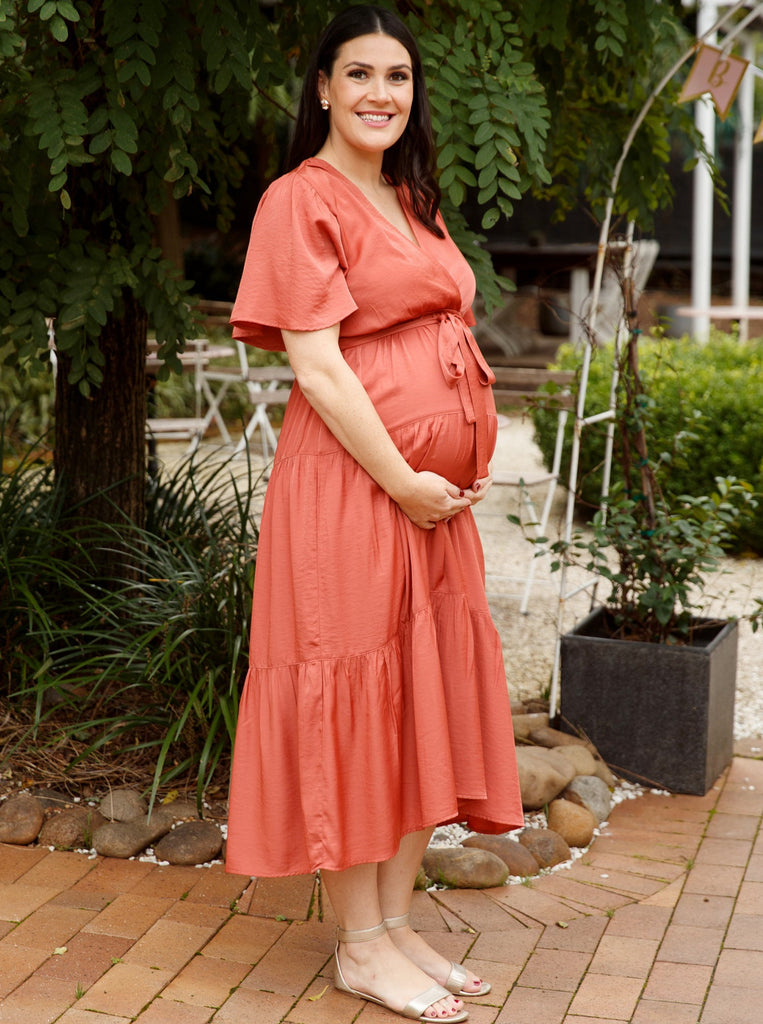 A woman in rust maternity dress, front2 (6677167865950)