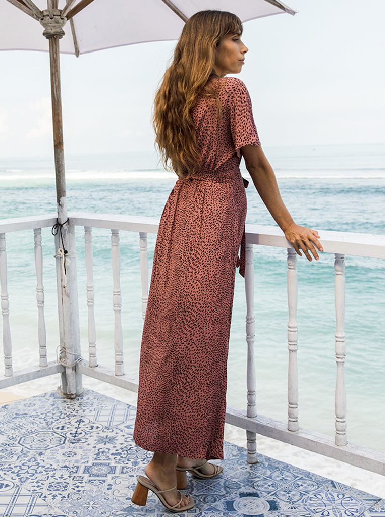 Back view - A pregnant woman in Rust Leopard Print Maternity & Nursing Maxi Dress looking at sea from a balcony near beach (6648841961566)