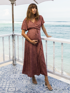 Main view - A pregnant woman in Rust Leopard Print Maternity & Nursing Maxi Dress touching her bump (6648841961566)