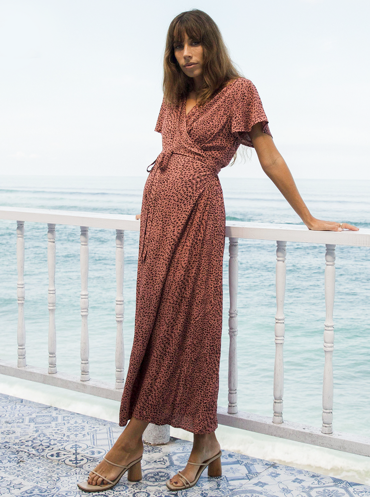 Front view - A pregnant woman in Rust Leopard Print Maternity & Nursing Maxi Dress standing on a balcony near beach (6648841961566)
