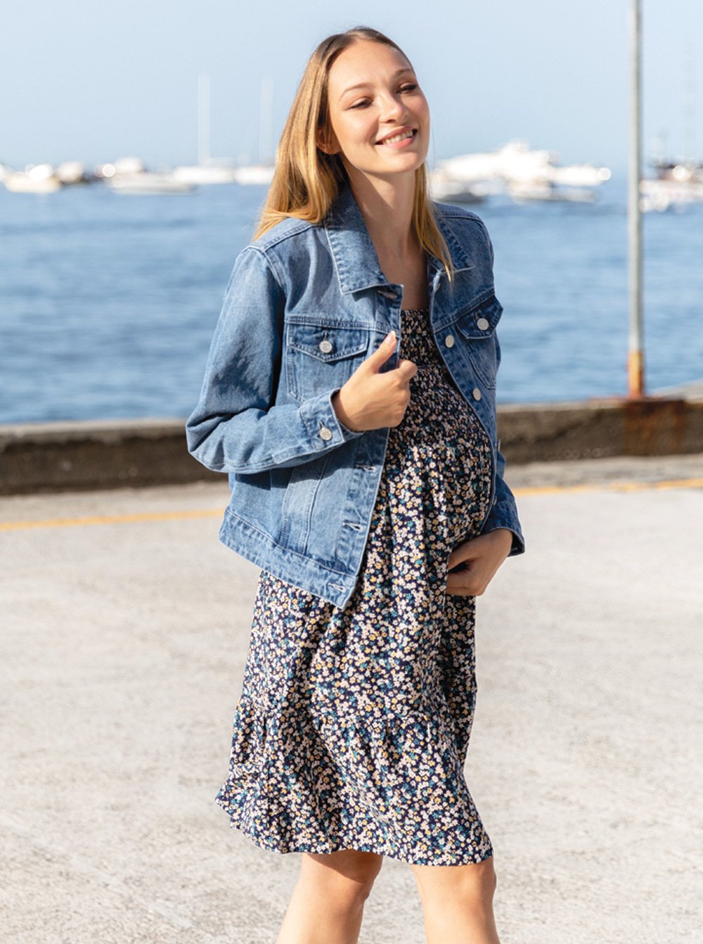 A woman in summer shirred flora maternity sun dress, full (6639694938206)