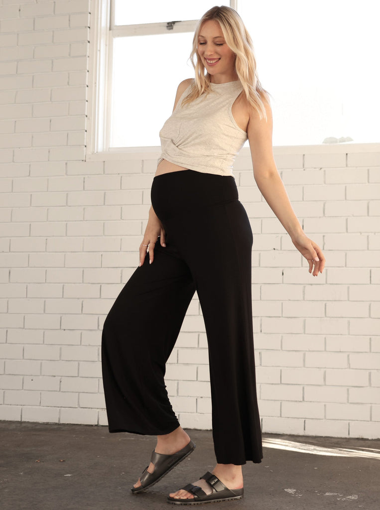 Main View - A pregnant Woman in Wide Leg Maternity Bamboo Pants in Black Color from Angel Maternity (6714932035678)
